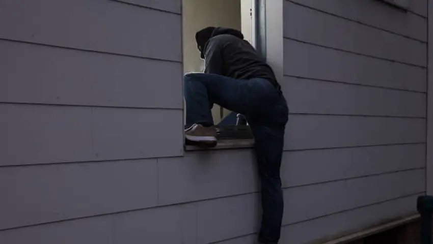 Burglar Entering House Through Window
