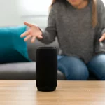 Stressed woman trying to connect her smart speaker that is not working